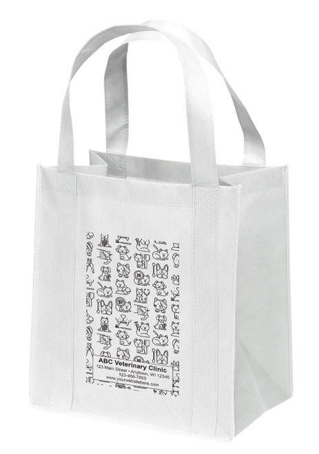 A reusable non-woven veterinary tote bag featuring an all-over doodle pattern of dog faces, cat faces, paw prints, bones, grooming tools, and veterinary-themed icons. Personalized clinic information is displayed in a rectangular text panel positioned near the bottom of the design.