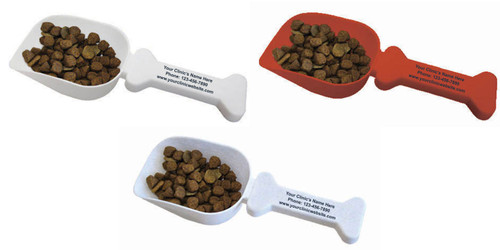  White and red bone shaped pet food scoops featuring black custom clinic information on the handle, including a sample clinic name, phone number, and website, with pet food shown in the scoop bowl.