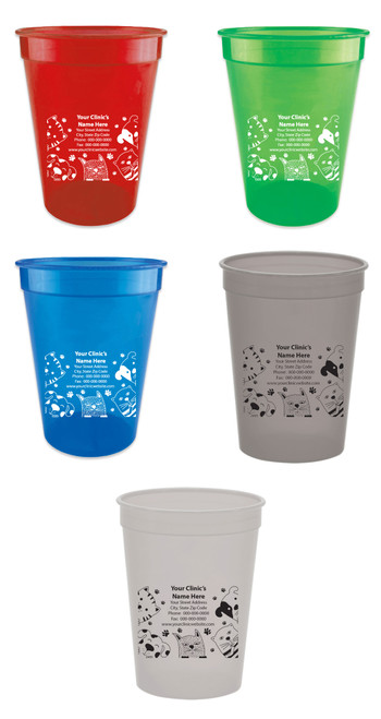 Personalized pet food measuring cup with multiple cartoon cat face illustrations surrounding a custom clinic information area. Paw print accents frame the design, with black or white imprint options shown on various cup colors.