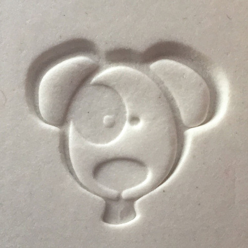 Metal Dog impression stamp creating a cat-shaped design in white clay, shown as an accessory for pet memorial and keepsake impression kits.

