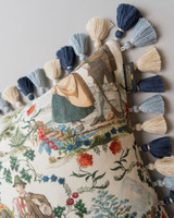 LANDHAUSMODE Cushion (LC40197) by Mind The Gap | LC40197 | TYROL APRES-SKI | 50 x 50 cm | Blue, White, Green, Red | Fringes all around | Duck feather | 56% Cotton, 44% Linen | Fabric Carolina | https://www.fabriccarolina.com/