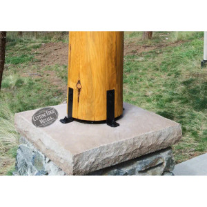 Round base uplift post brackets lift round log posts off of the ground to keep them dry. Our steel footings for posts have holes in them to mount to concrete and an access hole for tightening the concrete anchor or, if you wish, these steel brackets can be mounted only to the post and then sit directly on concrete. These are made in pieces. You have the uplift portion and the actual mounting brackets are separate. The purpose for this is to make sure that you have an easy time installing them on uneven or differentiating logs. Another option is to have us weld straps on the sides so that you can secure both the bracket to the cement and also the post to the bracket.