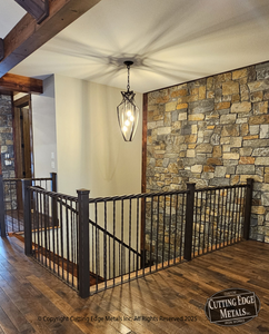 Decorative rope railing. Twisted steel, forming a rope, going across the top rail of this hammered, made from scratch, beauty of a railing. This has just the right amount of decorative touches and is a solid railing. Made with solid square bar, flat bar and 3" square tubing for the posts. We painstakingly, hammer the edges of this railing to give it dimension and design. We then make the caps from scratch, hammering them as well, and then put it all together for you from scratch. We then put the finish on it of your liking and can either ship it to you or install it, if you're close enough to our facility. Please call to discuss.