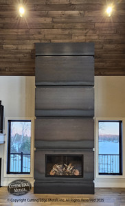 The "Matack" Surround. These custom fireplace surrounds were made for a great client of ours that has a beautiful cabin in the north woods of MN. The custom sizes and shapes of these two surrounds fit their space perfectly, complimenting the materials they used to build their retreat. Made of steel, these surrounds will last forever and the esthetics of them will be admired for generations to come.