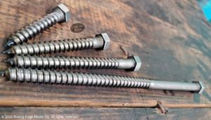 "Unfinished hex head lag screws in plain steel displayed on shelf – raw rustic lag bolts from Cutting Edge Metals for timber projects"