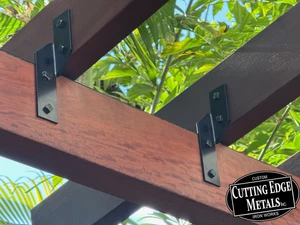 HT10 custom hurricane tie installed connecting rafter to beam on pergola roof structure, heavy steel construction with clean professional look