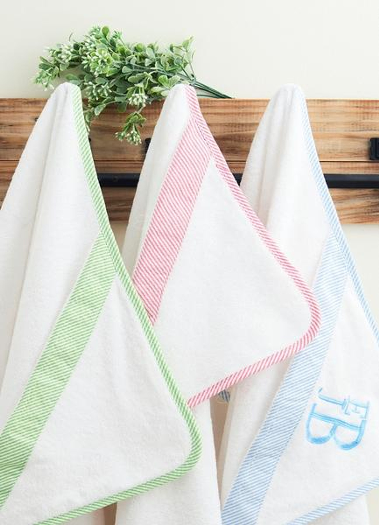 green, pink and blue hooded towel trio