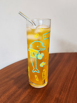 Ocean Life 13.5oz glass photo with orange liquid and a straw