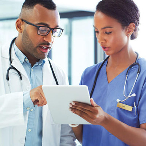 photo of doctor and nurse conferring over tablet