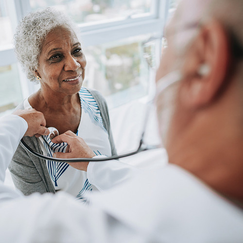 doctor examining geriatric patient