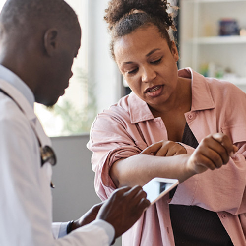 Doctor examining the arm of a patient