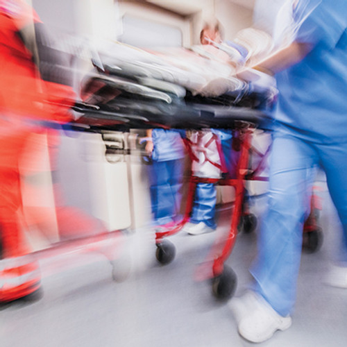 Blurred image of hospital staff pushing gurney