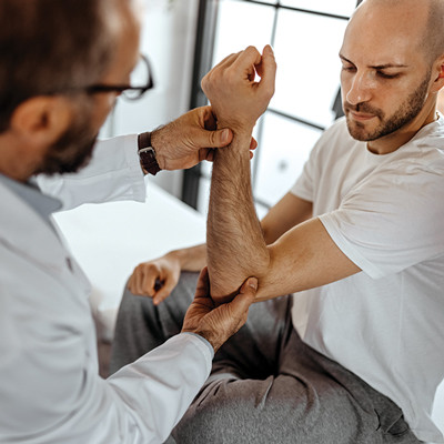 doctor examining patient's forearm