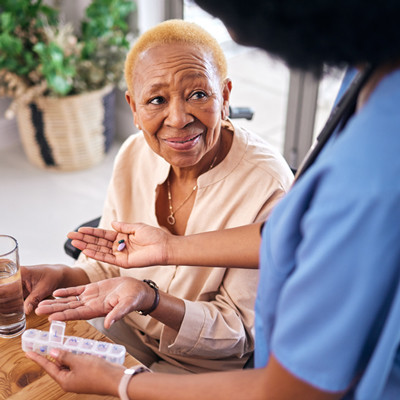 healthcare professional discussing medication with geriatric female patient