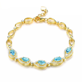 sky blue topaz and white zircon bracelet in 18k yellow gold over sterling silver