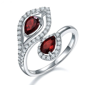 front view of garnet and white zircon bypass ring in rhodium over sterling silver