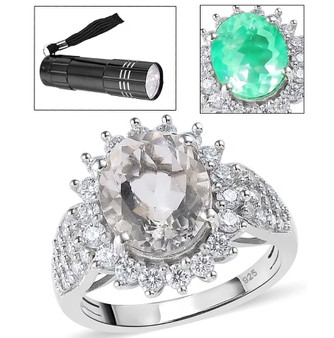 hyalite opal and moissanite oval halo ring glowing under uv flashlight showing green fluorescence front view