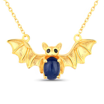 front centered view of bat necklace with oval sapphire body and black spinel eyes in 18k yellow gold over sterling silver