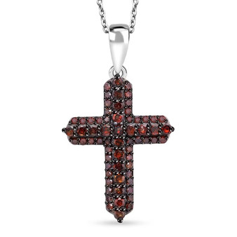 front view of the red diamond cross pendant showing the deep crimson sparkle and precision pavé setting under black rhodium finish