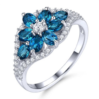 electric swiss blue topaz and zircon flower cluster ring in rhodium over sterling silver