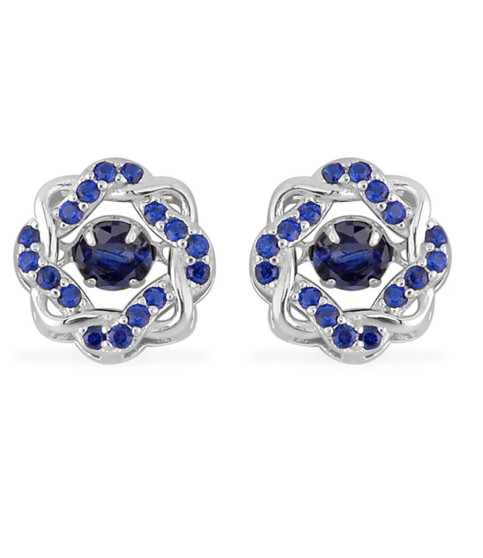 dancing blue cubic zirconia halo stud earrings in rhodium over sterling silver shown for size comparison