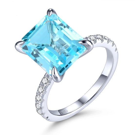 sky blue topaz white zircon and emerald cut solitaire ring in rhodium over sterling silver