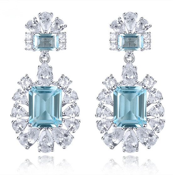 sky blue topaz and white zircon dangle earrings in rhodium over sterling silver