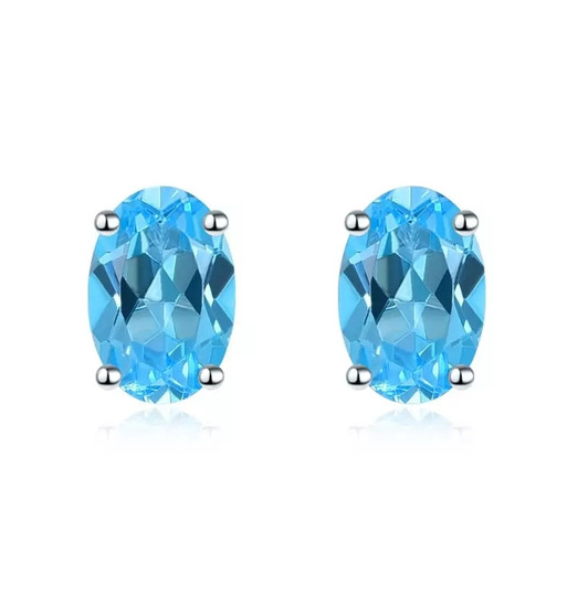 swiss blue topaz 6x4mm oval studs in rhodium over 925 sterling silver
