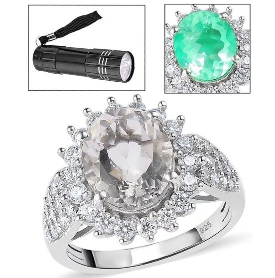 hyalite opal and moissanite oval halo ring glowing under uv flashlight showing green fluorescence front view