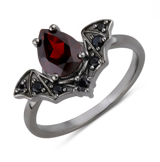 angled view of garnet and black spinel bat ring in black rhodium over sterling silver