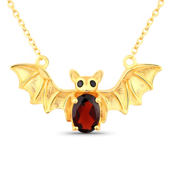 front centered view of bat necklace with oval red garnet body and black spinel eyes in 18k yellow gold over sterling silver