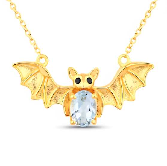 front centered view of bat necklace with oval sky blue topaz body and black spinel eyes in 18k yellow gold over sterling silver
