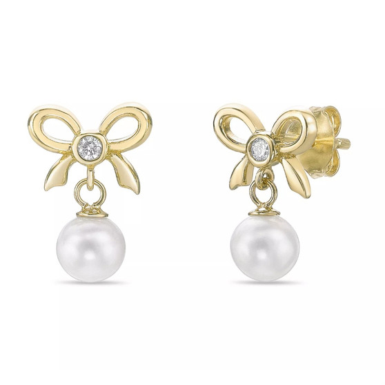 bow and pearl drop earrings with lab grown diamonds in 18k yellow gold worn on ear