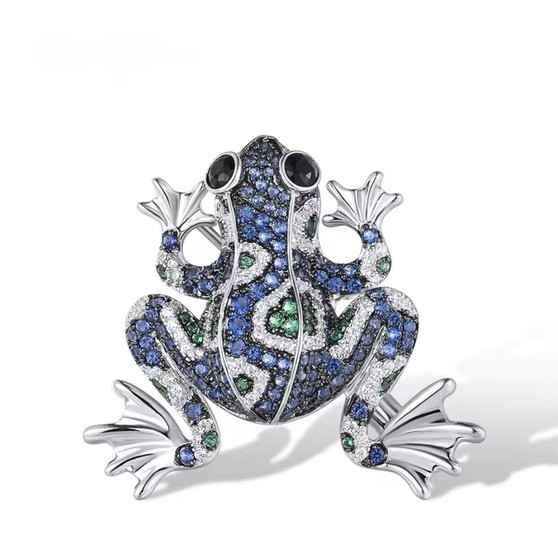 front view of blue and white cz lab green spinel and black spinel frog brooch in rhodium over sterling silver
