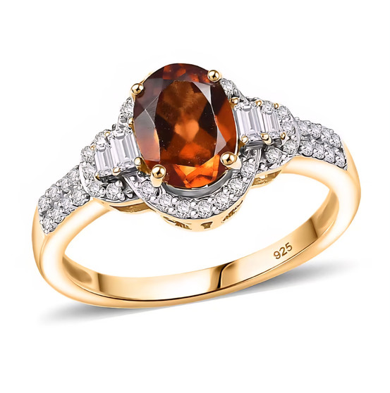 angled view of hessonite garnet and moissanite ring in 18k yellow gold over sterling silver