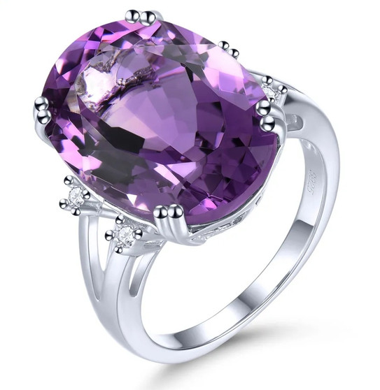 front view of amethyst and white zircon oval solitaire ring in rhodium over sterling silver