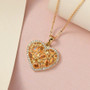 spessartine garnet and moissanite heart necklace in 18k yellow gold over sterling silver shown in a lifestyle photo