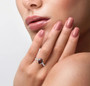 red zircon and white zircon wedding ring in rhodium over sterling silver worn on a hand