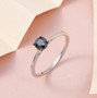 round black diamond solitaire wedding ring in rhodium over sterling silver shown in a lifestyle photo