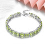 peridot mixed oval and emerald cut tennis bracelet in rhodium over sterling silver shown in a lifestyle photo
