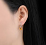 citrine and diamond in 14k white gold drop earrings on ear model