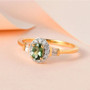 green apatite and zircon dainty halo ring in 18k yellow gold over sterling silver shown in a lifestyle photo