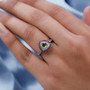 vesuvianite rhodolite and zircon trillion halo ring in rhodium over sterling silver worn on a hand
