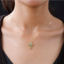 tsavorite garnet and white zircon cross necklace in 18k yellow gold over sterling silver worn around the neck