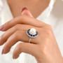 freshwater pearl sapphire and moissanite triple halo ring in rhodium over sterling silver worn on a hand