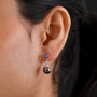 tahitian pearl tanzanite and moissanite drop earrings in rhodium over sterling silver worn on the ear