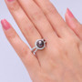 tahitian pearl and moissanite halo split shank ring in rhodium over sterling silver worn on a hand