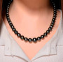tahitian pearl 8-12mm graduated necklace with 10k yellow gold 18-20" adjustable clasp worn around the neck