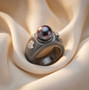 tahitian pearl guatemalan jadeite and moissanite dome band ring shown in a lifestyle photo