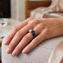 black and white moissanite black jade with rhodium over sterling silver ring worn on a hand